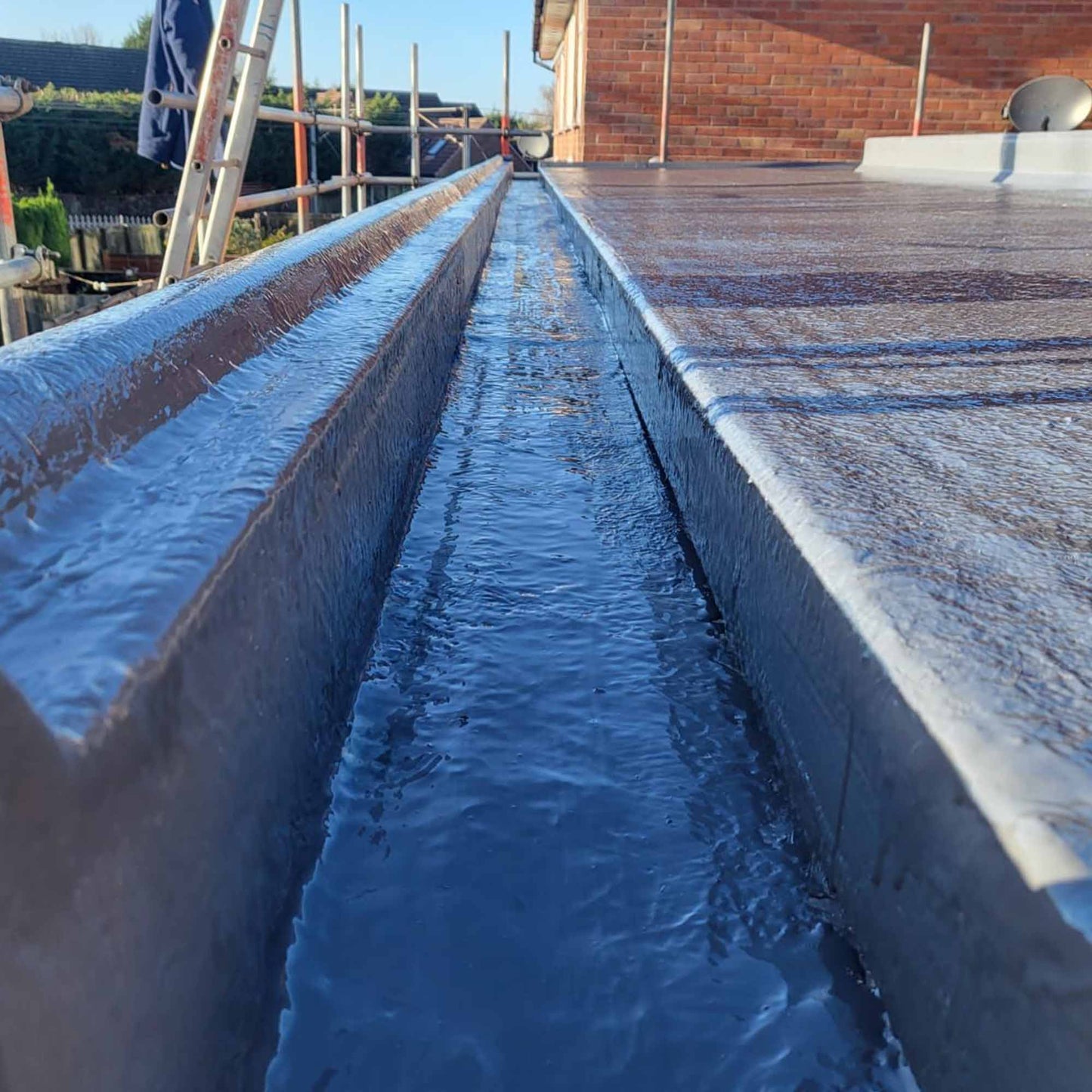 restec flexitec grp flat roofing system installed on a flat roof with a box gutter