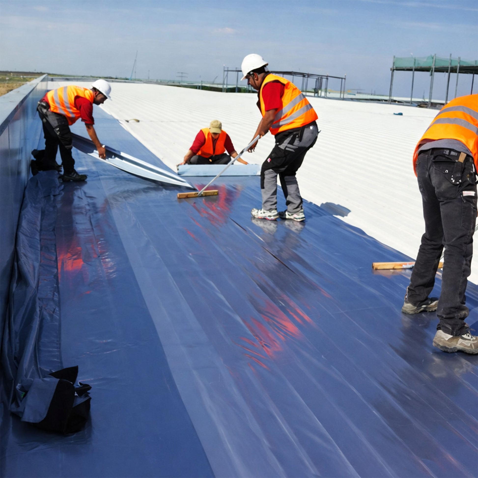 Vap-Air vapour barrier being installed by contractors on a commercial-sized flat roof