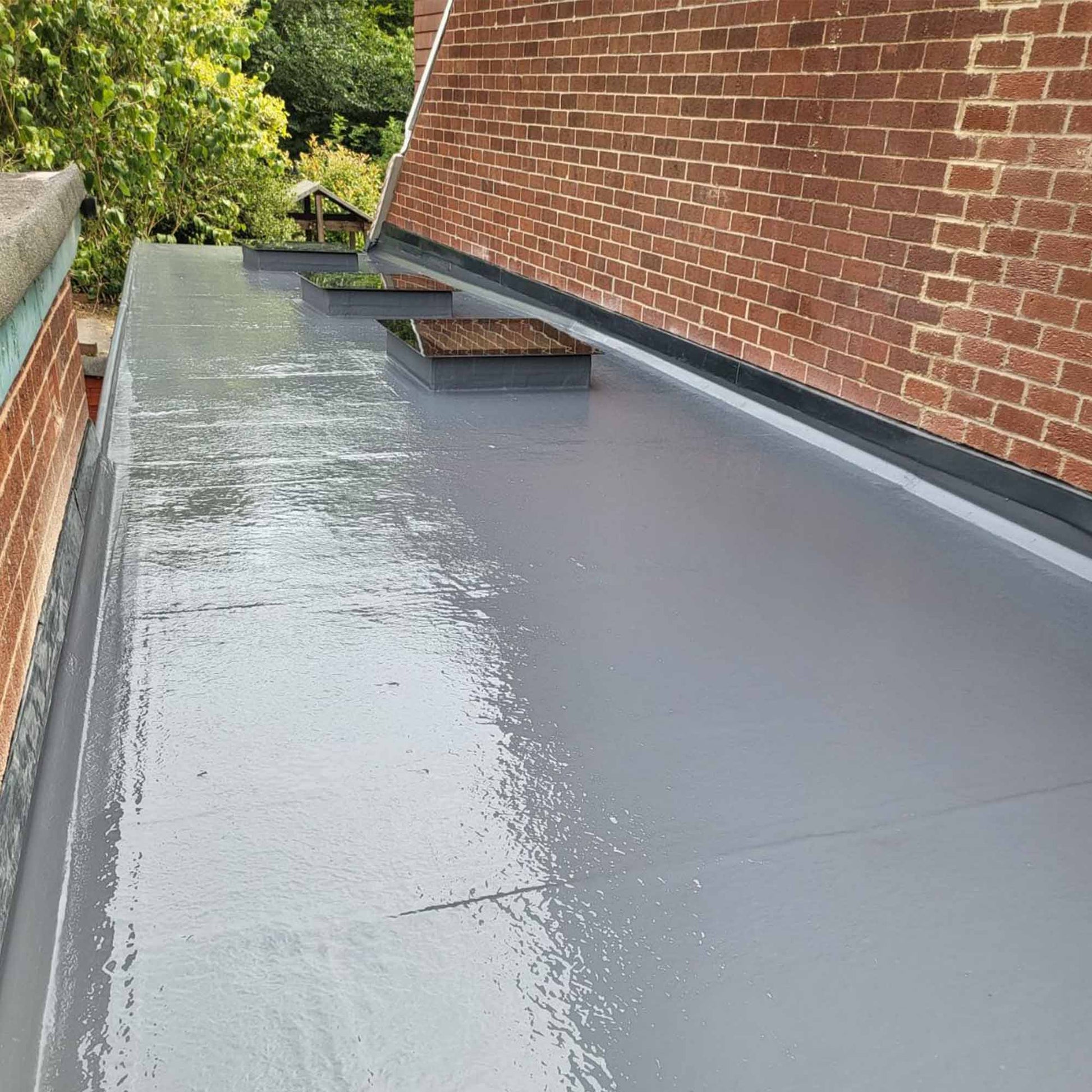 Restec flexitec fibreglass roofing system installed on a flat roof extension with 3 skylights