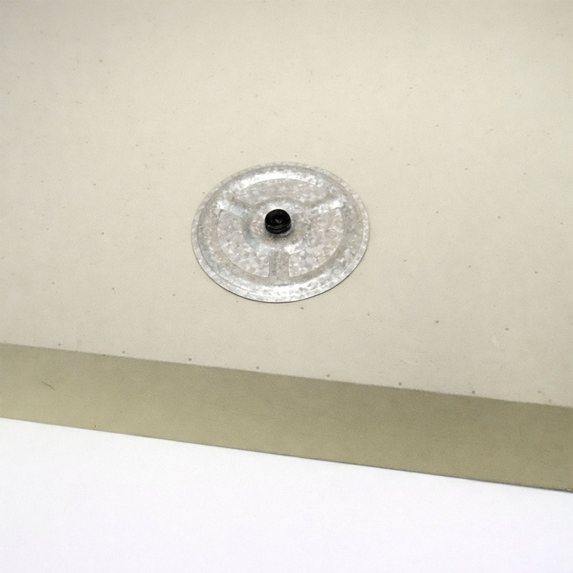 Insulation screw and washer screwed into insulation board on a flat roof