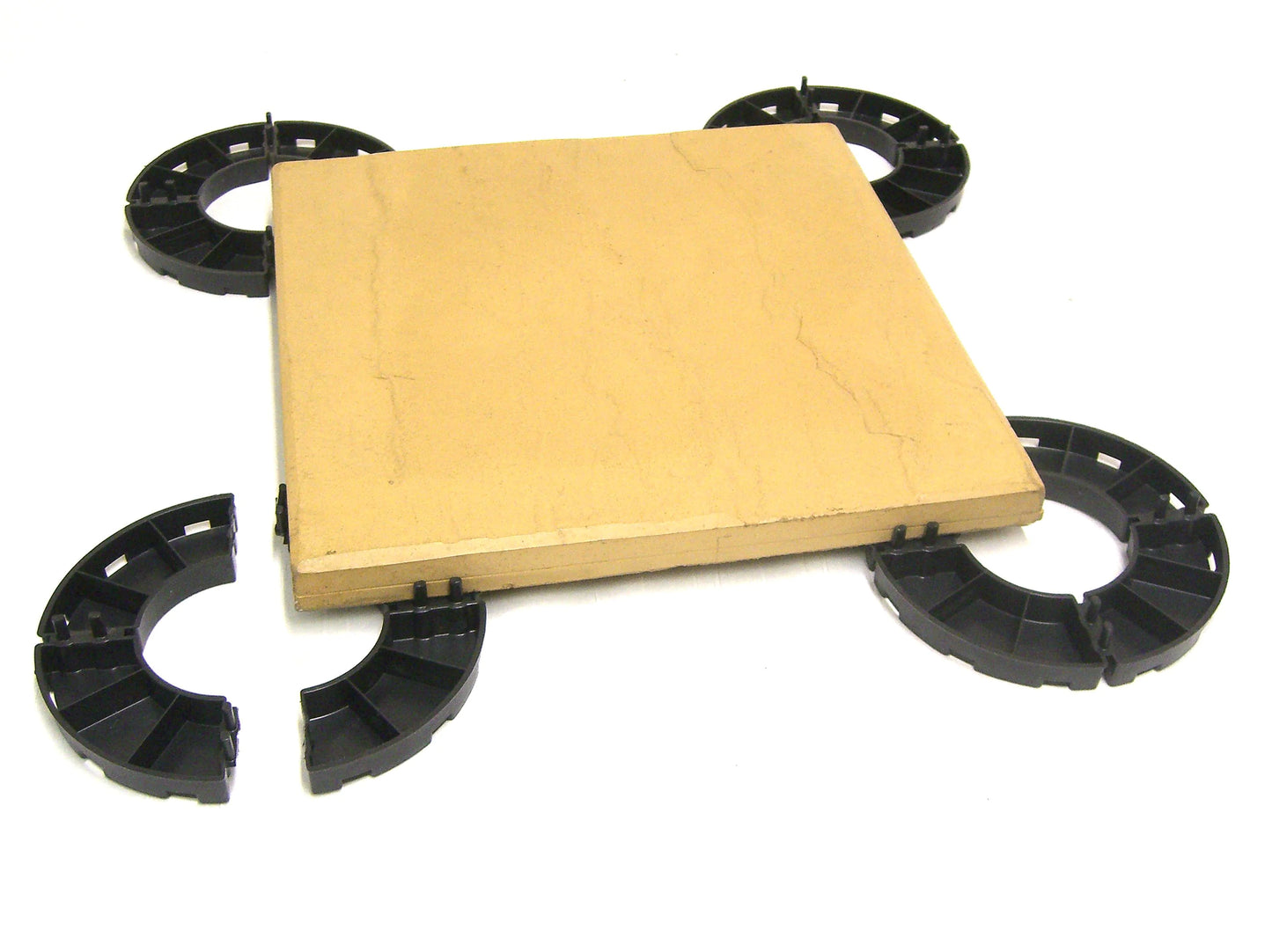 4 paving supports for balconies housing a ceramic tile on a white background