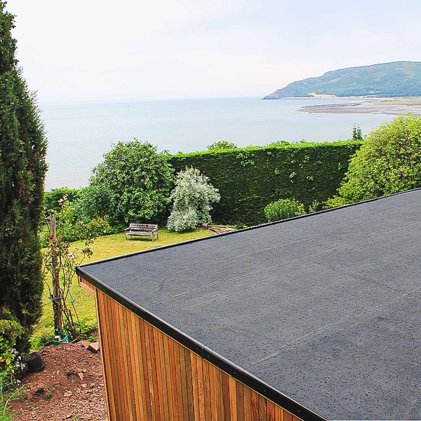 skyguard epdm rubber roof membrane fitted on flat roof with scenic coastal views