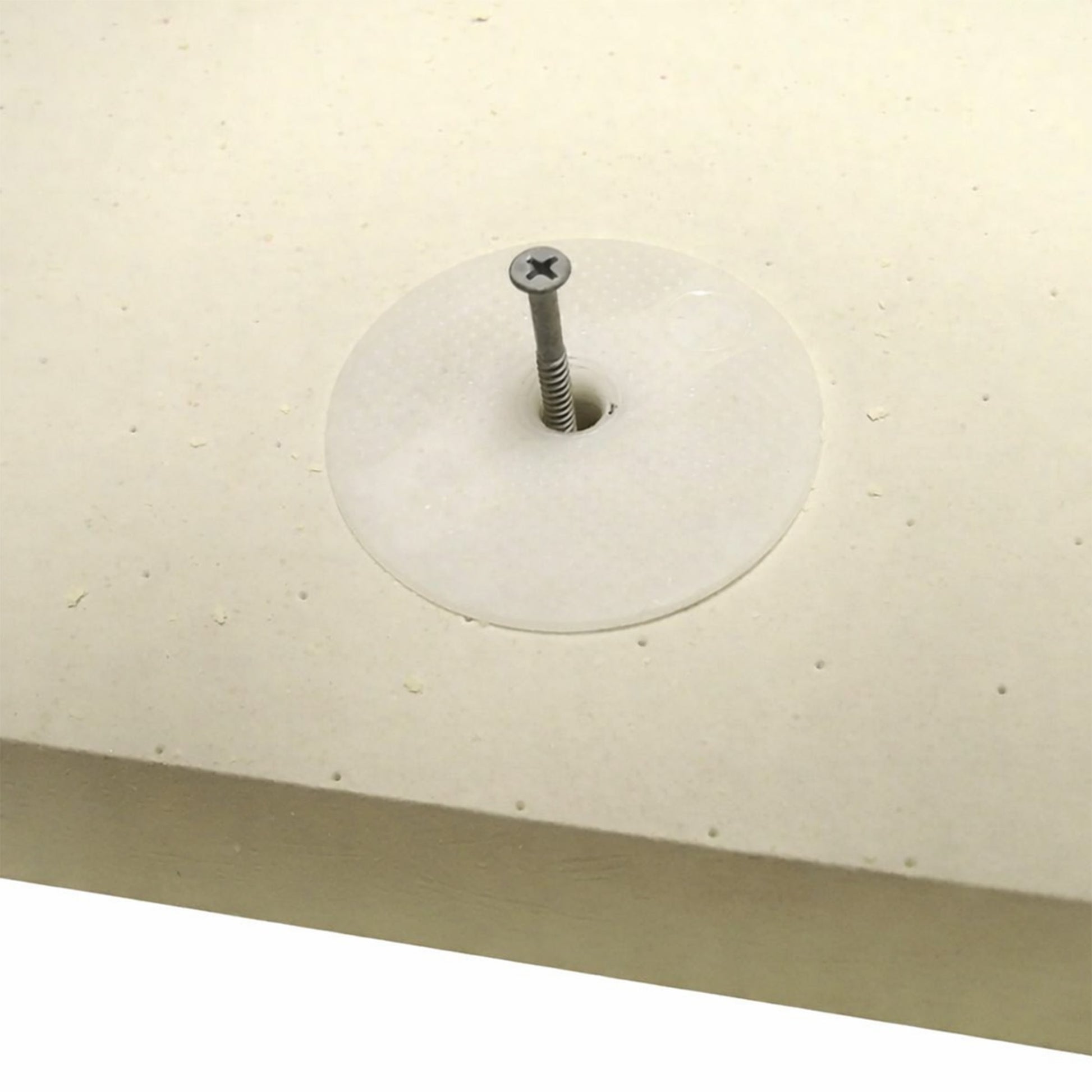 Close-up of a telescopic thermally broken warm deck flat roof fixing installed into a PIR insulation board
